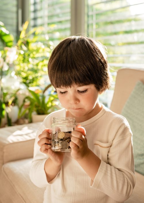 little-toddler-boy-holding-his-coins-money-saving-2025-02-12-00-50-14-utc